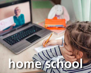 A young girl studies at home