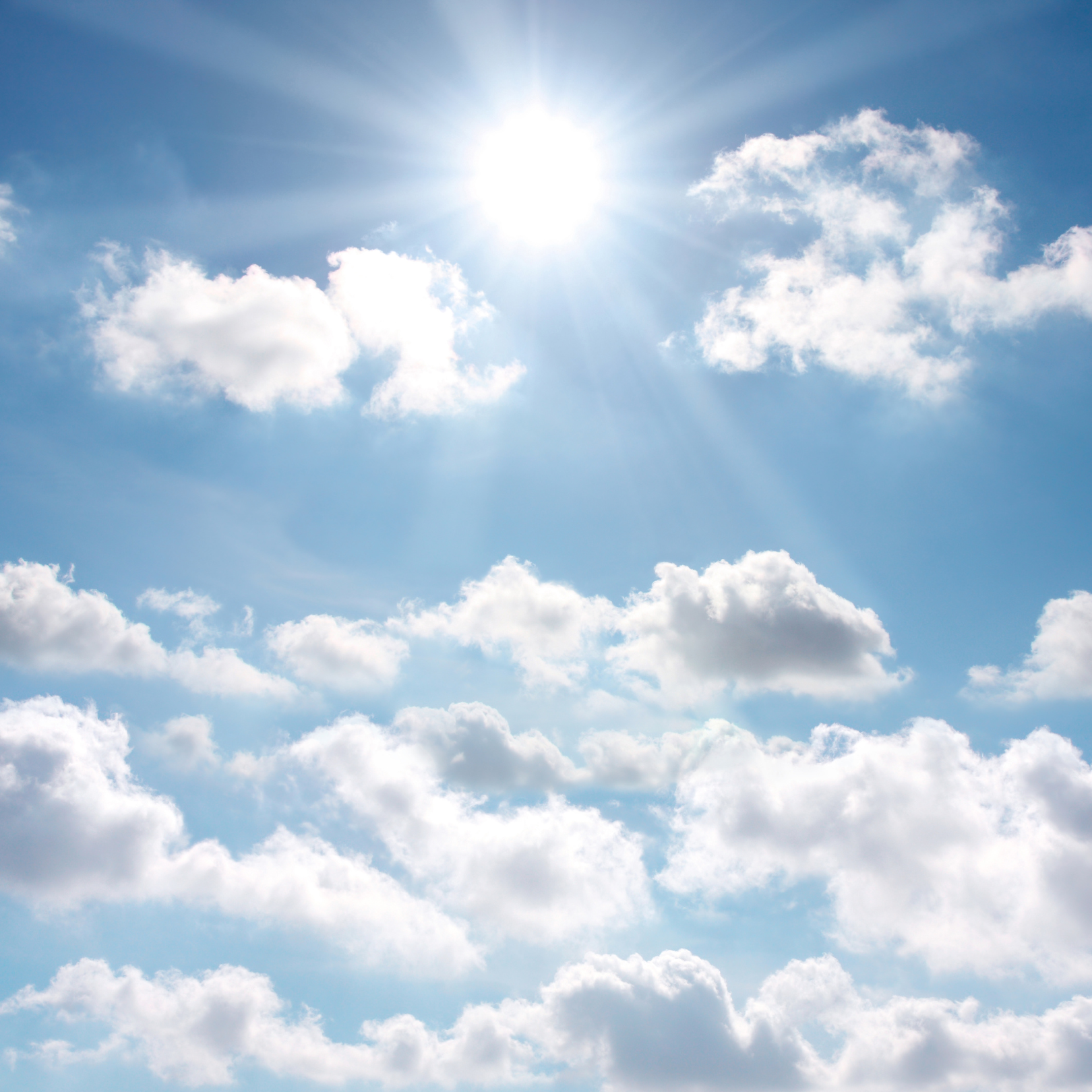 Image of the sun and blue sky and white clouds