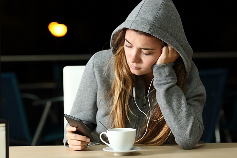 A teenager useing her phone
