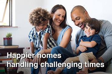 Mixed race family with two children relaxing on a sofa