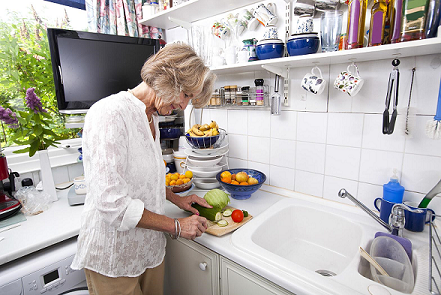 A woman prepares food in her kitchen