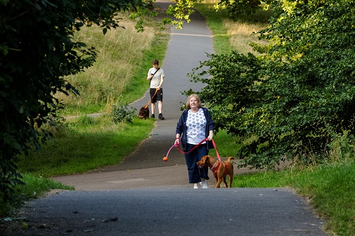 A woman walking with her dog