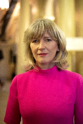 A person in a pink shirt

Description automatically generated