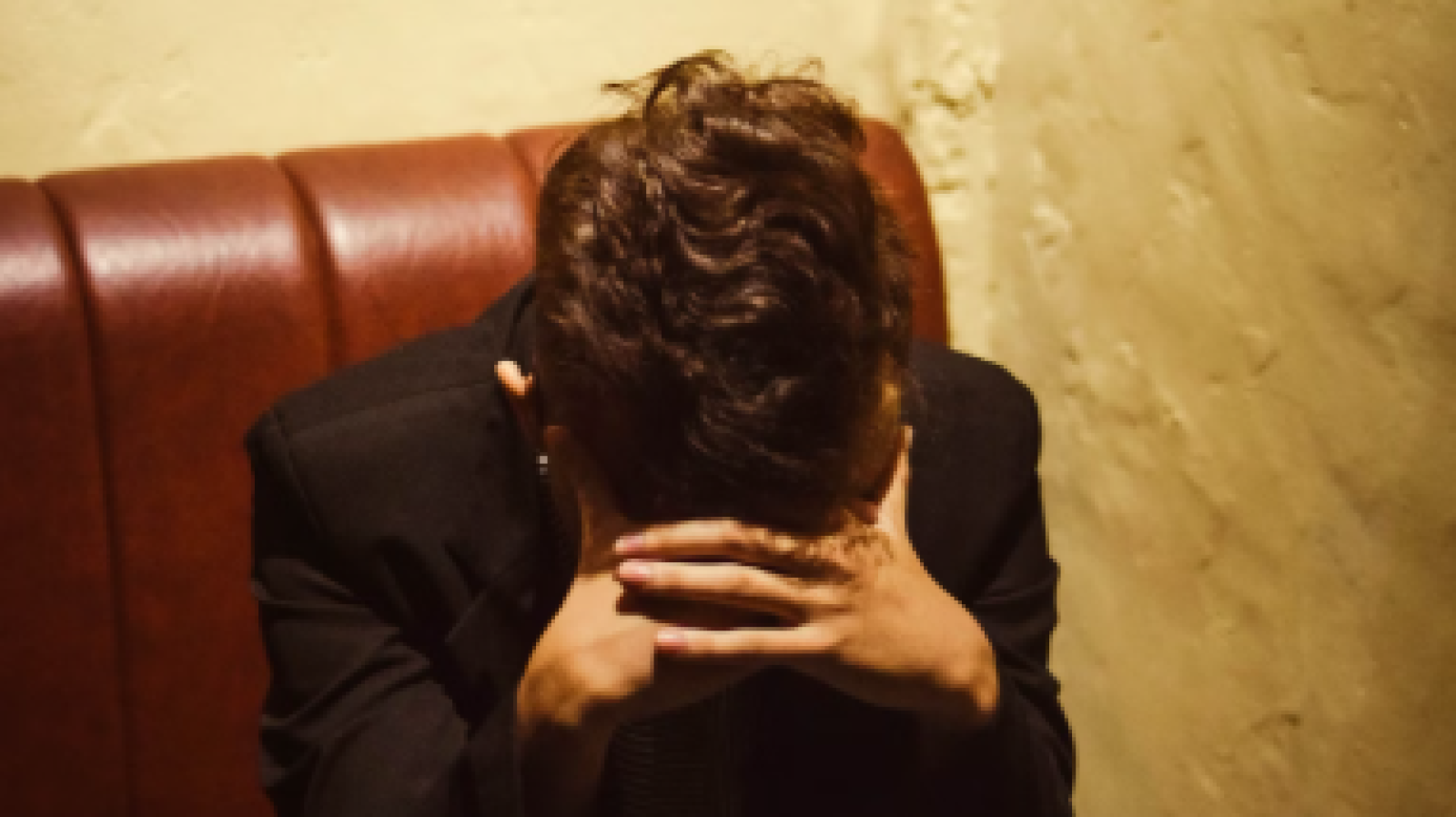 woman holding her head in her hands 