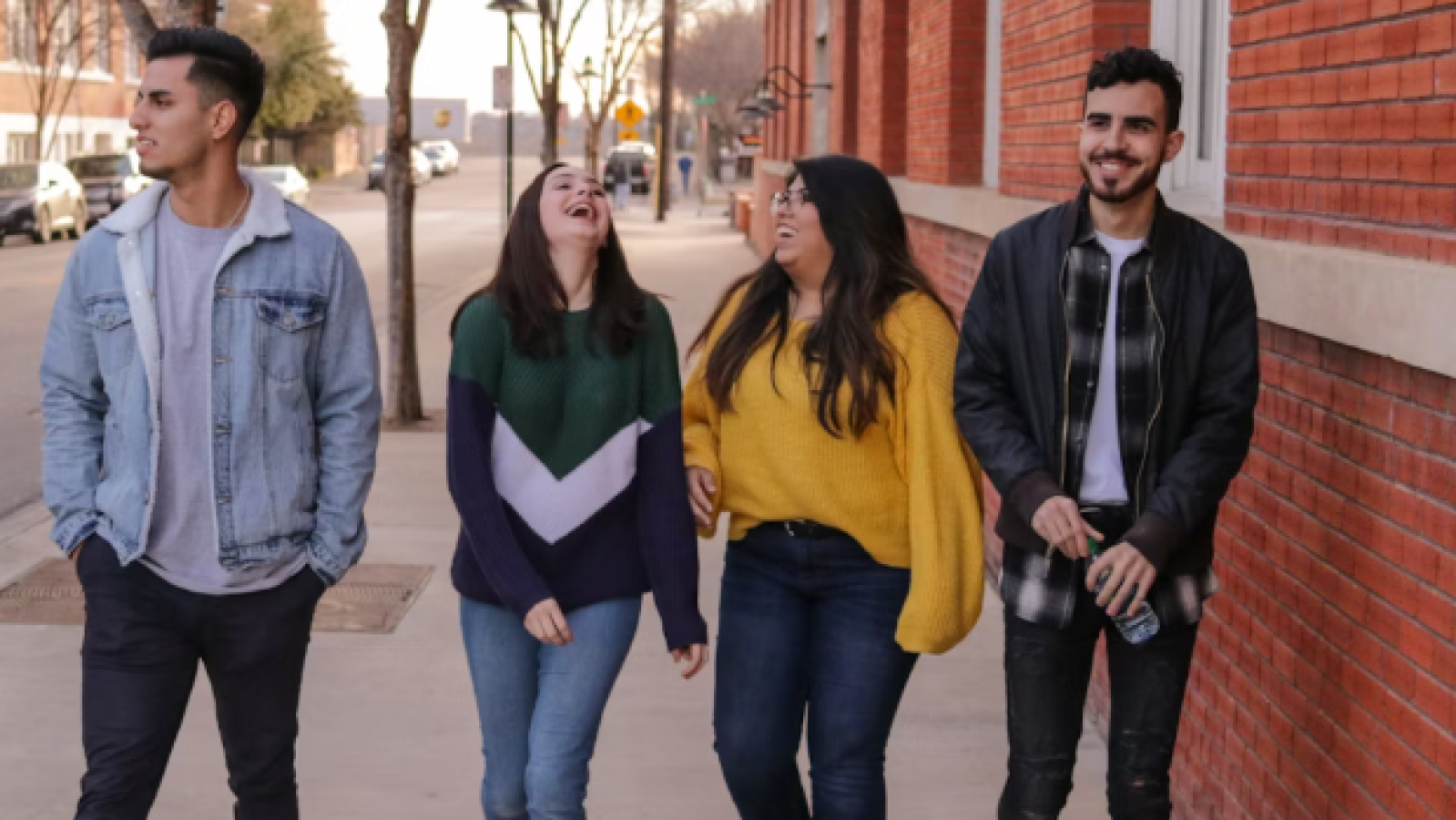 a group of young people walking down the street 