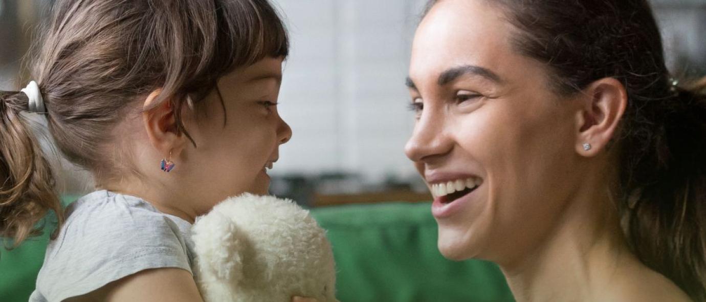 woman and a little girl with teddy bear